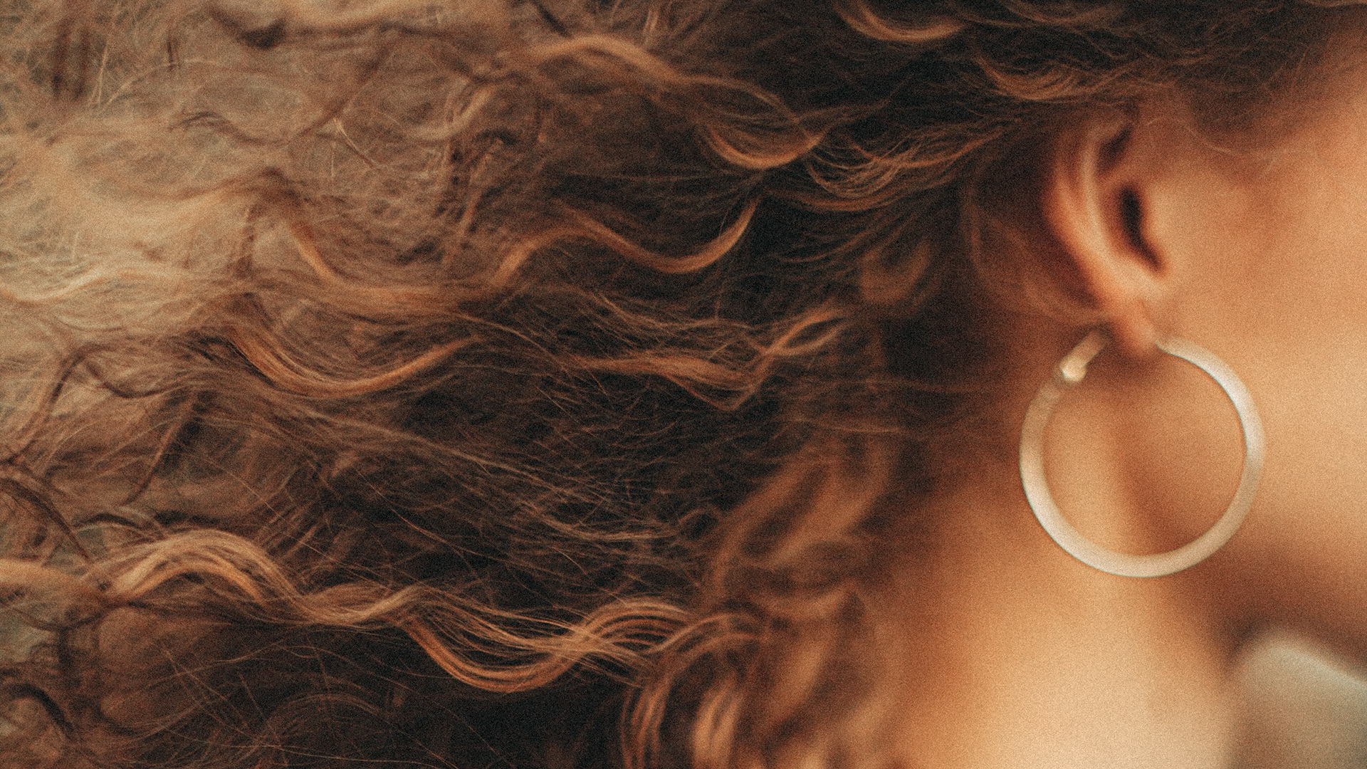 Profile of woman with curly brunette hair