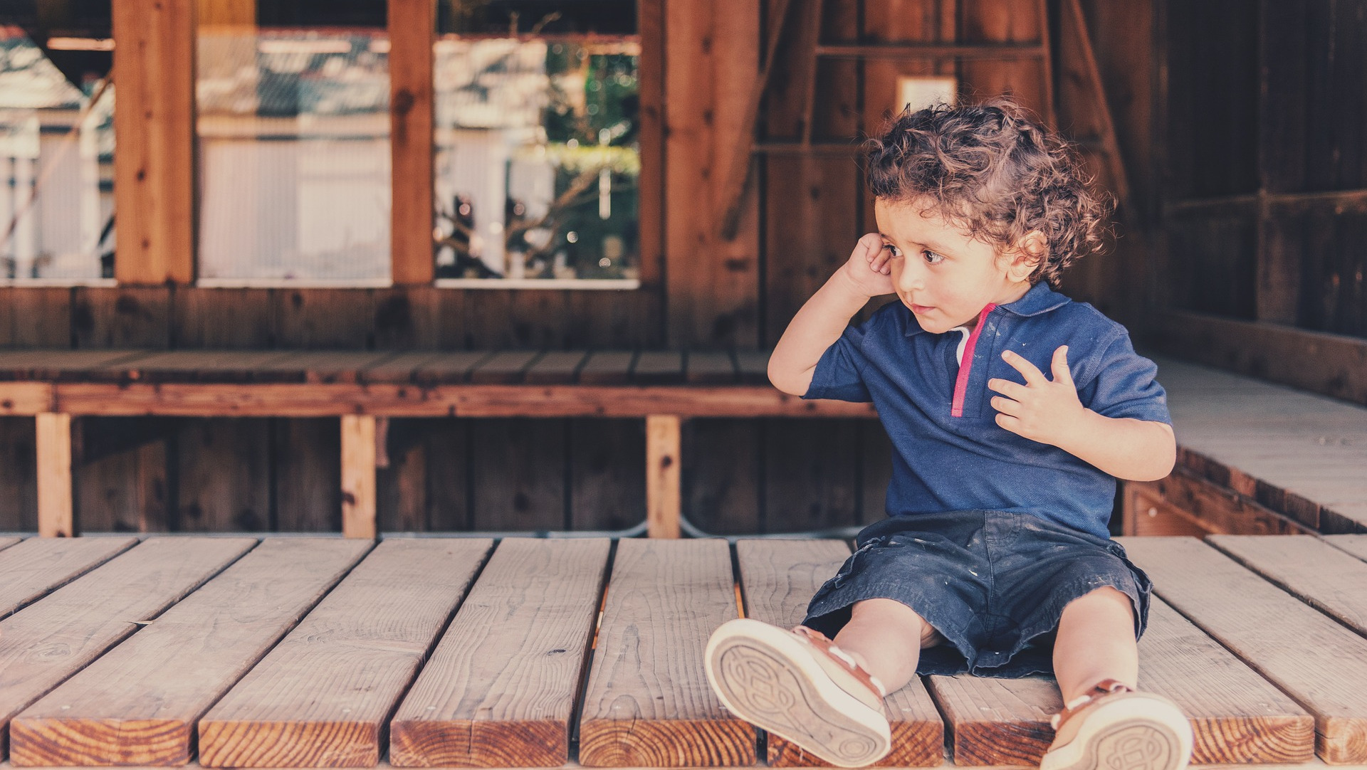 Young Child Rubbing Ear with Ear Ache.