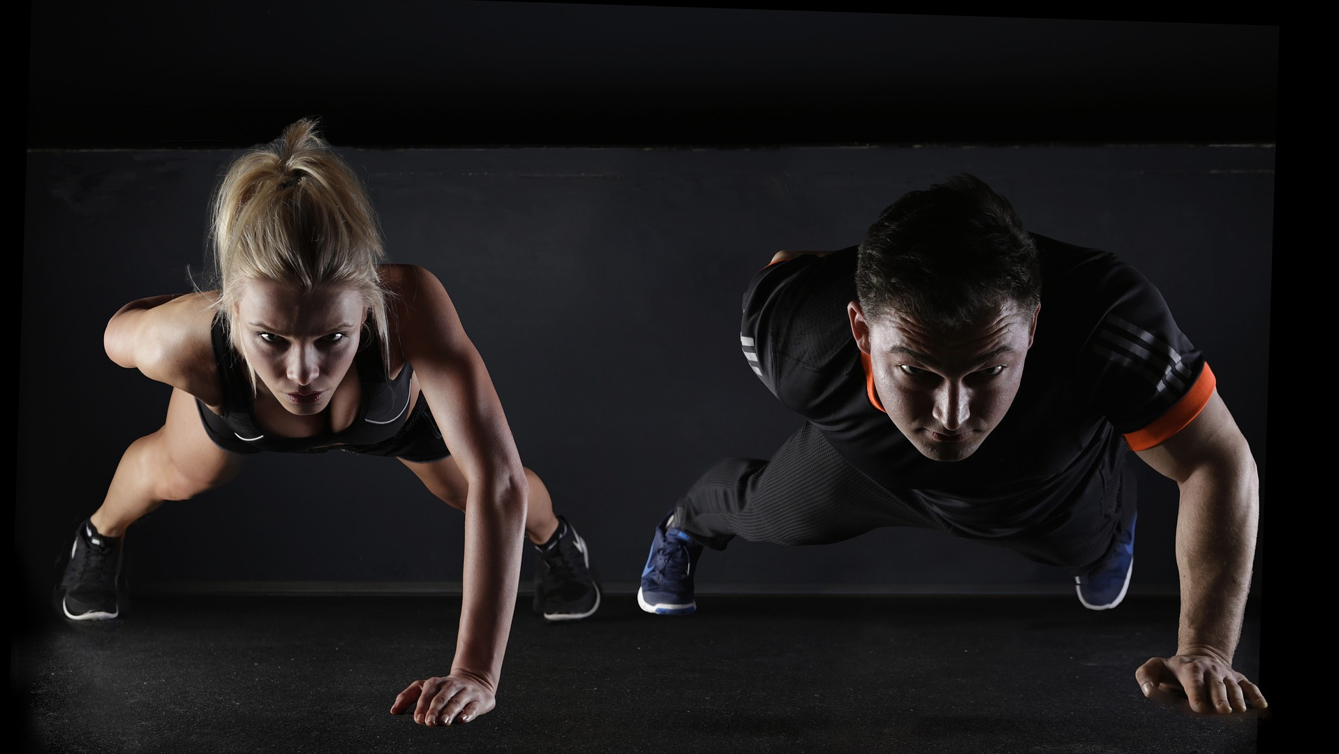 man and woman doing push ups