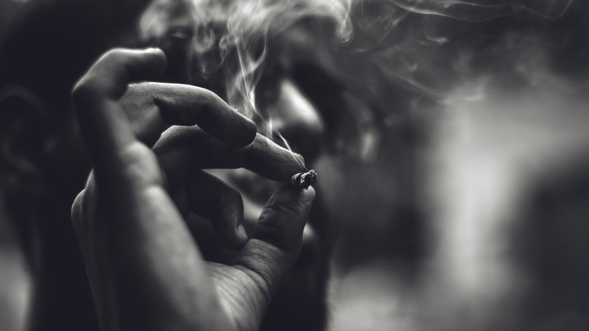 Black and white image of a man smoking