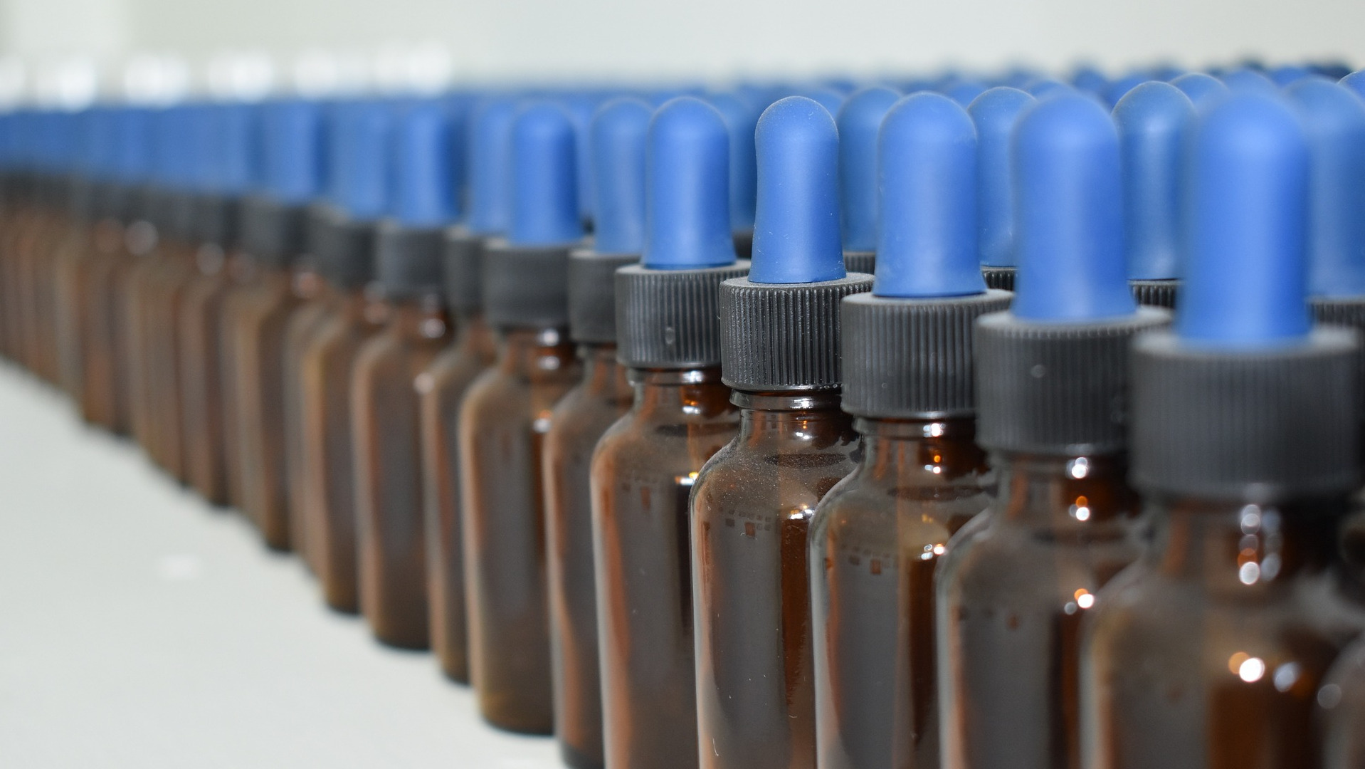 Row of unfilled homeopathic solution bottles